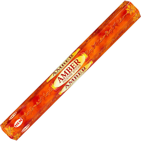 A pack of Hem hexagonal incense in a amber color, with branding and text visible on the packaging.