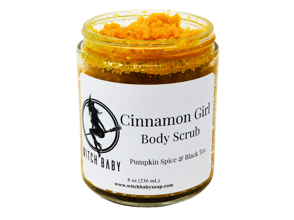 Pumpkin orange granulated body scrub packaged in a 8 oz (236 mL) glass jar.  White label reads: Cinnamon Girl Body Scrub. Pumpkin Spice & Black Tea. 