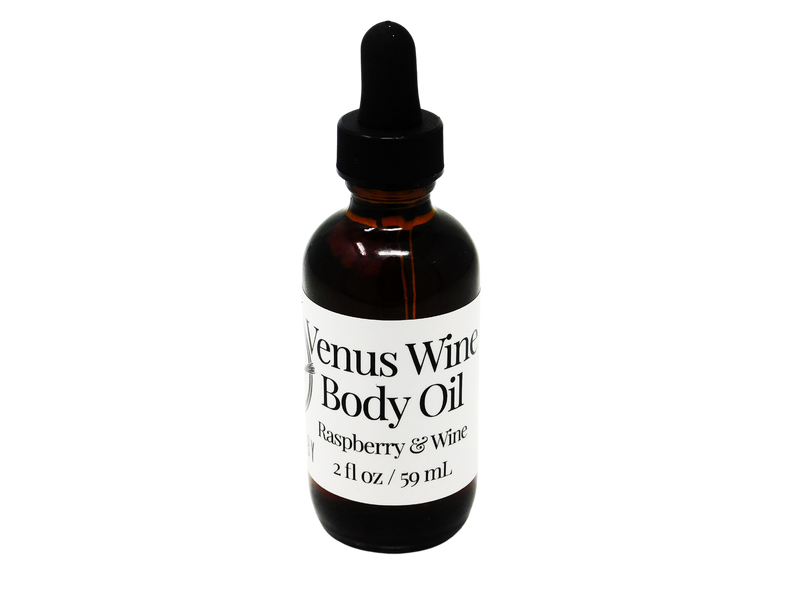 2 oz brown glass dropped bottle with a white label that says Venus Wine. Raspberry & Wine.